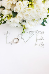 The word "Love" made up of flowers on a white background