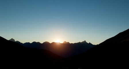 sunset on the dark mountain in silhouette