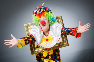 Clown with picture frame in funny concept