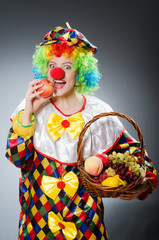 Clown with fruits in funny concept