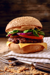 Closeup of home made burger on wooden background