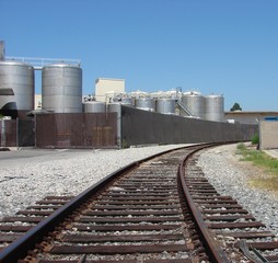 Fototapeta na wymiar rail tracks approaching industrial plant