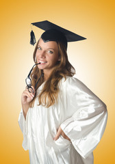 Young student with diploma on white