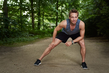 Obraz premium Athletic Man Doing Warm Up Exercise at the Park