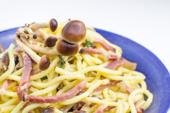 mushrooms on the italian pasta troccoli with smoked ham and rock