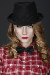 young beautiful girl in a hat and red shirt