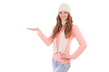 Obraz na płótnie Canvas Cute smiling girl wearing scarf and cap isolated on white