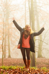 Woman walking in park in foggy day