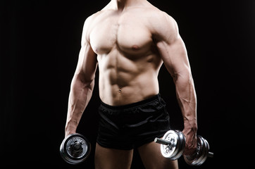 Muscular ripped bodybuilder with dumbbells