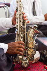 .Saxophone old man with hands.