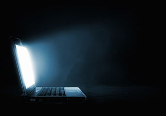 Glowing laptop - Powered by Adobe