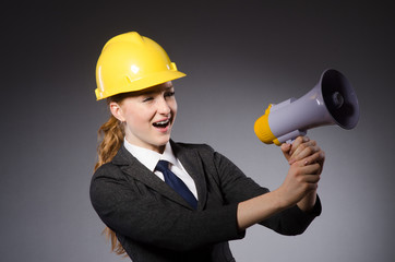 Fototapeta premium Construction worker in helmet against gray