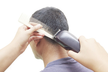 Barber cutting hair with clipper