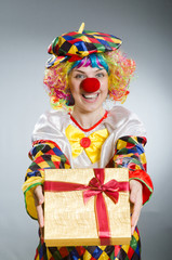 Clown with giftbox in funny concept