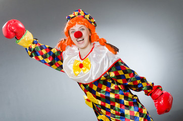 Clown with boxing gloves isolated on white