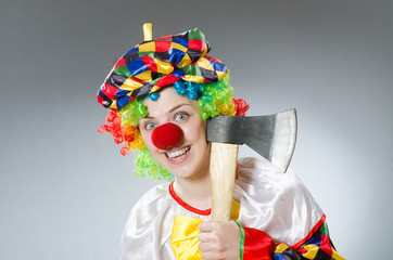 Clown with axe in funny concept