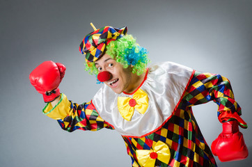 Clown with boxing gloves isolated on white