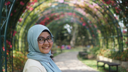 portrait of muslem women smiling on a camera inside flower park