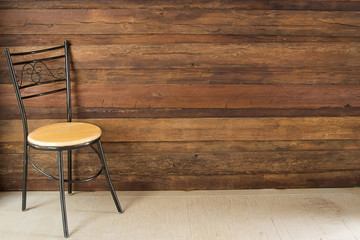 chair in an empty room with wooden floor and background