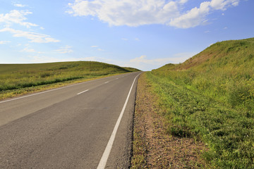 Road among farm fields.