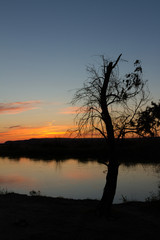 Naklejka premium sunset over the river
