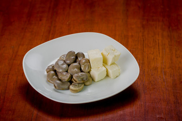 Pile of cooked abbas next to small stable square pieces cheese
