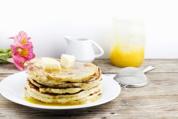 pancakes with apple and honey on wooden table