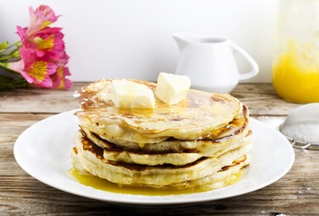 pancakes with apple and honey on wooden table
