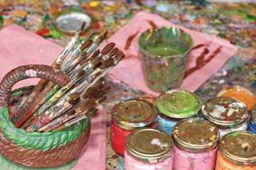 Many Paintbrushes And Paint In The Jar On The Palette