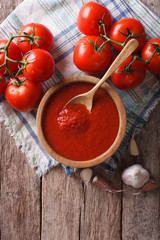 tomato sauce with garlic and basil in a bowl. vertical top view
