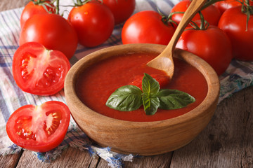  red tomato ketchup and basil in a wooden bowl closeup. horizontal
