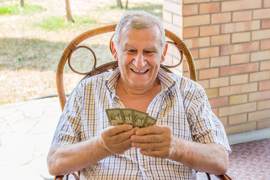octogenarian elder play cards on the patio