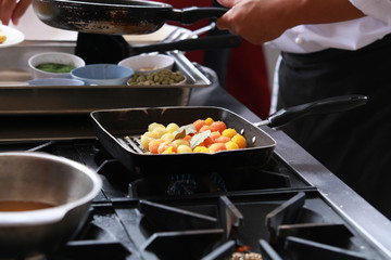 Chef in restaurant kitchen cooking
