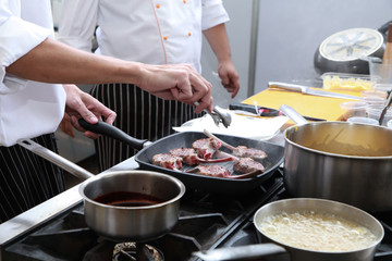 Chef in restaurant kitchen cooking