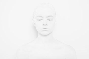 Girl with White Paint on the Skin on a White Background