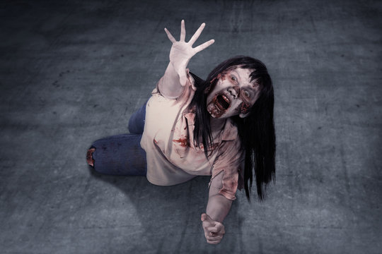 Female Zombie Crouching On The Floor