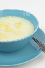 Blue bowl of cauliflower and potatoes soup.