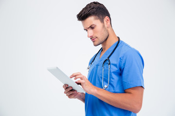 Male doctor using tablet computer