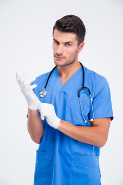 Handsome Male Doctor Putting Gloves