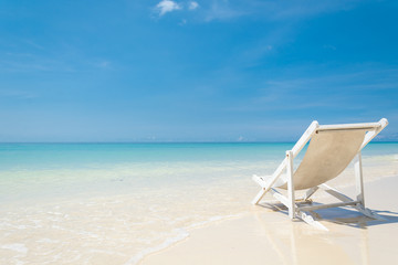 beach chair on beach with blue sky