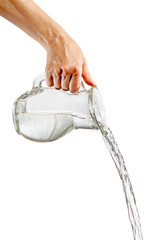 Hand pouring water from glass jug