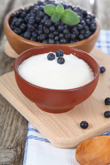 Blueberries in a bowl and sugar