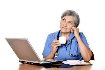 Smiling senior doctor  with laptop