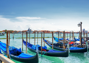 Fototapeta na wymiar Gondolas parked beside the Riva degli Schiavoni in Venice, Italy