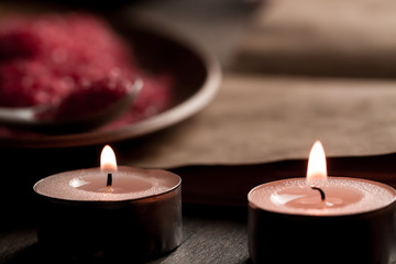 Obraz na płótnie Canvas Beautiful Spa composition with aroma candles and empty vintage open book on wooden background. Treatment, aromatherapy