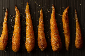 whole roasted carrots with spices in a skillet. Vegetarian healthy food