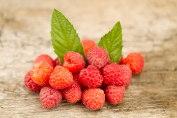 ripe raspberries closeup on wooden background