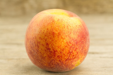ripe fresh peaches on wooden background