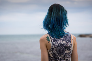 Blue haired girl stand on the ends of the earth