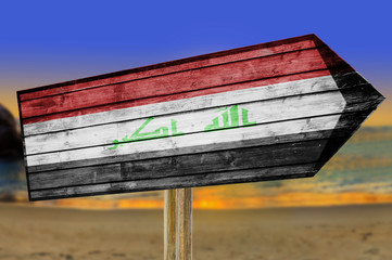 Iraq Flag wooden sign on beach background